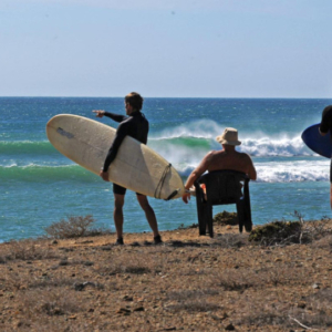 Surfers study waves, Mag Bay Mexico