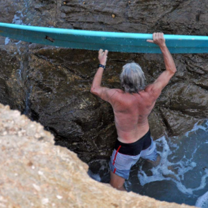 longboard surfer getting out of the water, Mag Bay Mexico